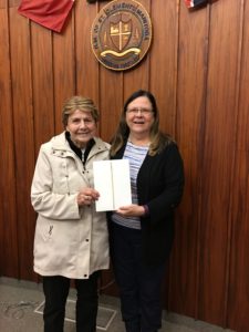 Betty Skrypnyk receiving the iPad she won for completing the Let's Talk Trash survey from Mayor Debbie Fiebelkorn