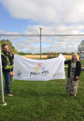 RM of St. Clements Public Works Lead Hand Darren Otto and Mayor Debbie Fiebelkorn with the Rotary Peace Flag on September 19, 2018